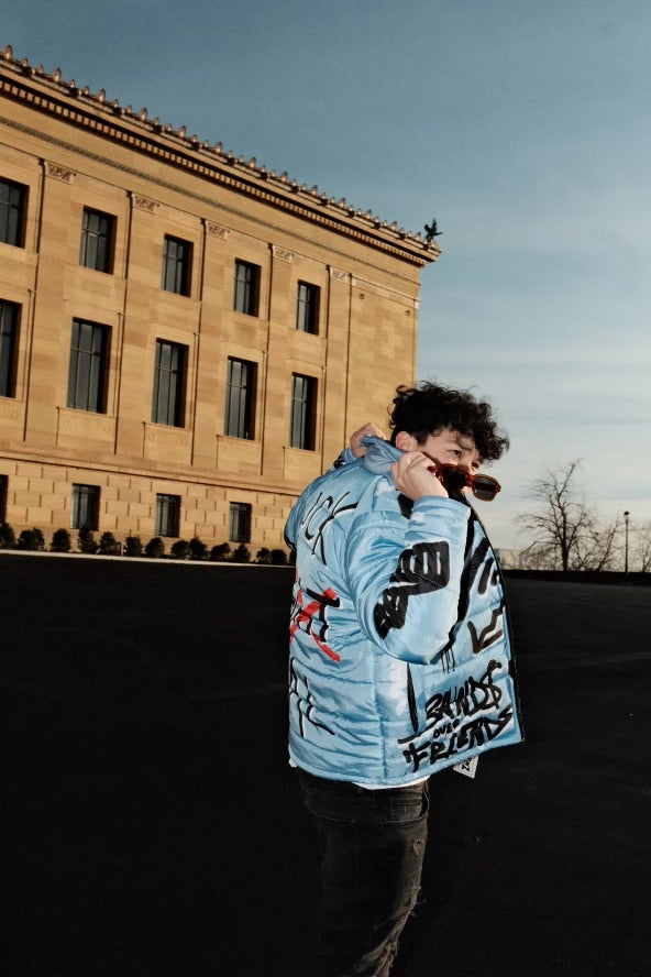 “Luck Is Not Real" Baby Blue Graffiti Puffer Jacket