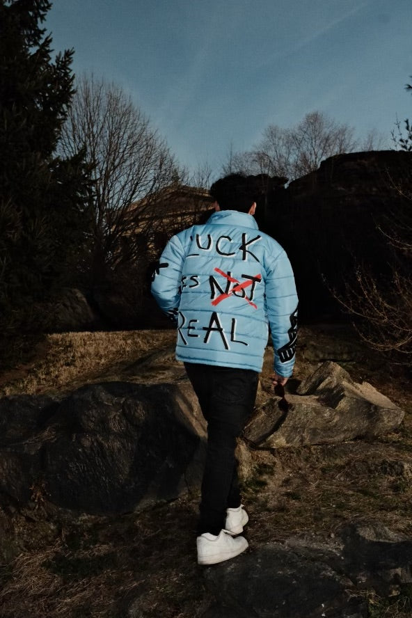 “Luck Is Not Real" Baby Blue Graffiti Puffer Jacket
