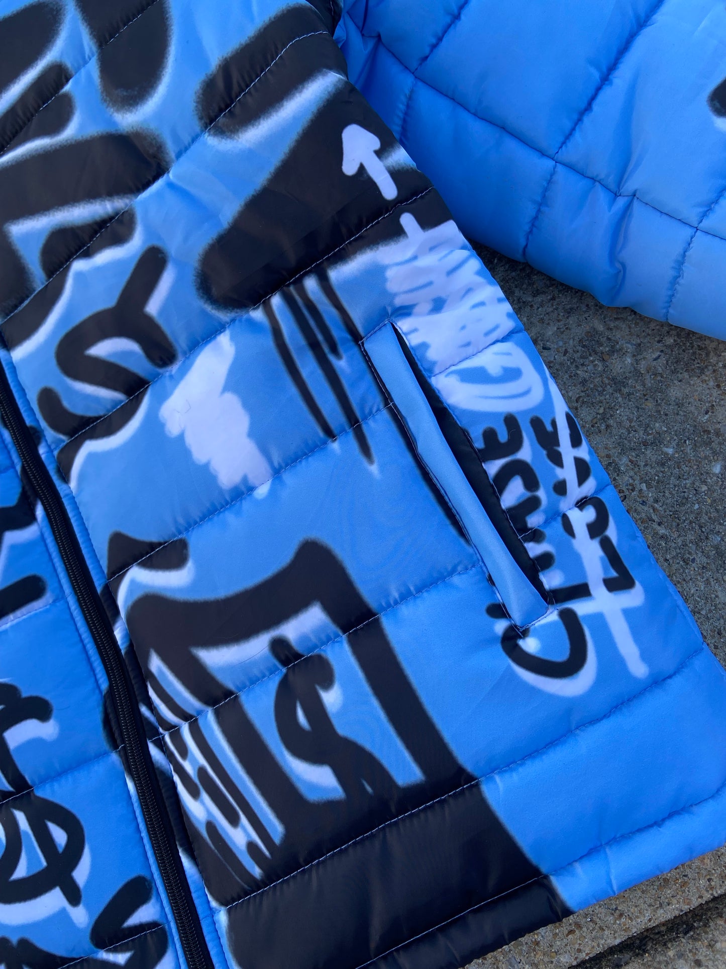“Luck Is Not Real" Baby Blue Graffiti Puffer Jacket